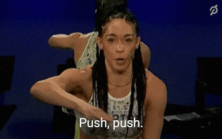 Video gif. Peloton instructor Hannah Frankson directing with her arm and saying "push, push."