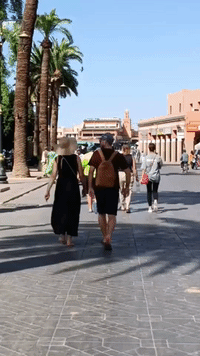 Tourists and Locals Stroll Marrakech Square Damaged by Quake