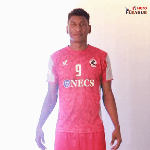 Sports gif. Willis Plaza of Aizawl Football Club looks up and raises his arms in praise.
