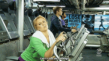 Celebrity gif. Amy Schumer is on  an elliptical machine at a busy gym. She is leaned over, practically melting, on this machine as she tiredly says, “Can't I just do nothing?”