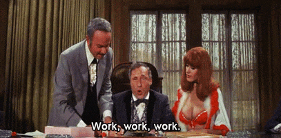 Movie gif. Mel Brooks as Governor William, Harvey Korman as Hedley, and Robyn Hilton as Miss Stein in Blazing Saddles. The Governor is acting petulant as he sarcastically says, "Work, work, work," while bouncing around in his seat.