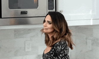 Celebrity gif. YouTuber Rosanna Pansino turns to face us in a kitchen, smiling and holding up her crossed fingers. 