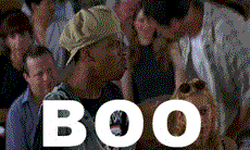 Movie gif. On Half Baked, a man in an audience stands and throws his hat yelling, “Boo this man!”