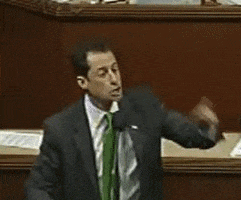 Politics gif. Anthony Weiner speaks behind a microphone, pointing his finger in the air for emphasis. Text appears, "Kudos to you!"