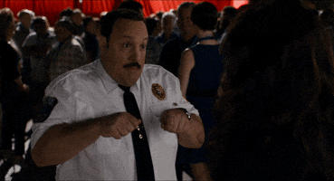 Movie gif. Kevin James as Paul Blart in Paul Blart: Mall Cop holds his hands up to his chest as if riding a segway as he jerks back and forth. 