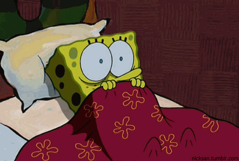 SpongeBob gif. SpongeBob shudders and blinks with wide eyes as he lays in bed with the covers pulled up under his nose.