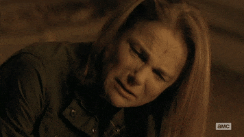TV gif. Tovah Feldshuh as Deanna in The Walking Dead appears tearful as she looks up from the ground and says "do it." Scene cuts to a man whose face is covered in blood who turns away, and then to Andrew Lincoln as Rick who shoots his gun.