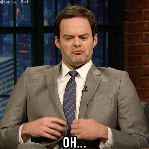 Celebrity gif. Bill Hader on Late Night with Seth Meyers adjusts his gray suit jacket and pouts with a protruded lower lip. Text, "Oh..."