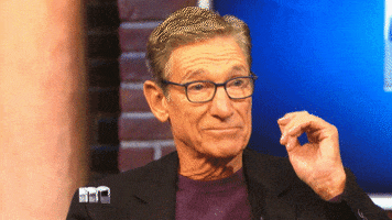 Reality TV gif. Maury from Maury reels back in shock as he blinks quickly and reaches towards his glasses.