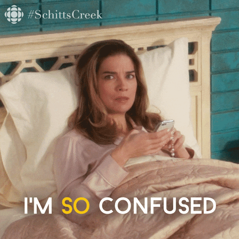 Schitt's Creek gif. Annie Murphy as Alexis lies in bed in her pajamas. Looking up from her phone, she says, "I'm so confused," which also appears as text.