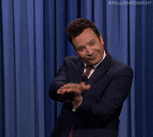 Tonight Show gif. Jimmy Fallon looks at us with a sarcastic smile as he claps big, awkward claps, and shakes his head around. 