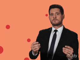 Celebrity gif. In front of an orange background resembling a can of Bubly water, Michael Buble makes finger-guns at us and nods with a straight face. Text, "You got this."