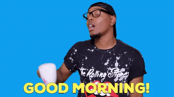 Video gif. A man says, "Good Morning," while raising a mug of coffee and pulling back, looking sassy and expectant for a reply.