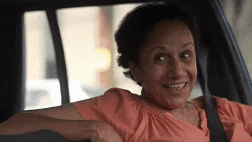 TV gif. Peggy Blow as Abuelita, Marisol Martinez, in On My Block, sits in the driver's seat, parked, her arm up on the back of the seat, as she smiles and nods. 