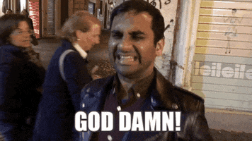 Music video gif. In video for Kanye's "Famous," on a city street, Aziz Ansari thrashes backward and forward, shouting "God damn!" which appears as text.