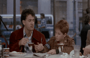 Movie gif. Tom Hanks as Josh from Big takes a cherry from the sundae of his friend Jared Rushton as Billy. Josh starts to eat the cherry, then opens his mouth and shows it to Billy, and Billy doesn't seem to care one way or the other.