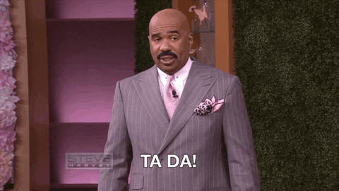 A video gif of Steve Harvey in a suit. He awkwardly opens his arms up in a "ta-da" motion, as if he's showing something off, with the words "ta-da" on the bottom of the screen.