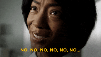 Movie gif. We see Betty Gabriel as Georgina in Get Out in a closeup as she looks at someone with a strained smile, tears on her cheek, as she shakes her head slightly but frantically, saying, "No, no, no, no, no, no..."