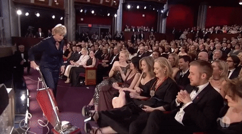 Ellen DeGeneres using a vacuum