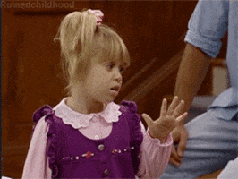 TV gif. Michelle from Full House has her arm raised with her palms open and sassily turns away while rolling her eyes.
