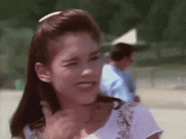TV gif. Amy Jo Johnson as Kim in the Power Rangers winks as she gives an energetic thumbs up. 