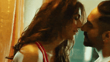 Movie gif. Vaani Kapoor as Maanvi pulls Ayushmann Khurrana as Manu toward her for a passionate kiss in Chandigarh Kare Aashiqui.
