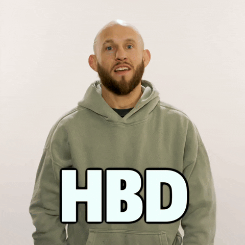 Video gif. Brian Kelleher, a UFC fighter, holds his hands up with a pleasant manner and mouths "Happy Birthday" to us in front of a beige background. Text, "HBD."
