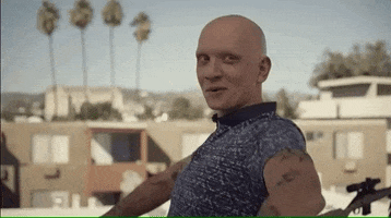 TV gif. Anthony Carrigan as Noho Hank in Barry pumps his shoulders and arms in a happy dance.