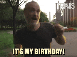 Video gif. Fran Healy from the band Travis jumps up and down excitedly, hopping from one foot to the other.. Text, "It's my birthday!'