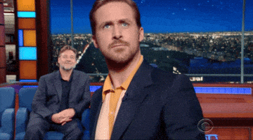The Late Show gif. Ryan Gosling is leaving an interview and he walks towards the cameras, getting so close that he's out of focus. He frowns before raising his hand at us and waving, saying, "Bye!"