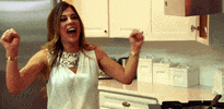 Reality TV gif. Siggy Flicker from Real Housewives of New Jersey is happy and doing a little dance in her house.