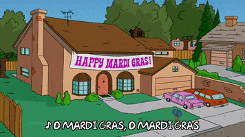 Simpsons gif. The exterior of the Simpson's home is has a sign hanging that says, "Happy Mardi Gras!" A pair of hands reaches up to string lights. Text, "O Mardi Gras O Mardi Gras."