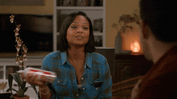 TV gif. Christina Milian as Vanessa and John Stamos as Jimmy in Grandfathered. She vigorously shakes a can of whipped cream and takes a shot of the whipped cream straight from the bottle while chatting with Jimmy.