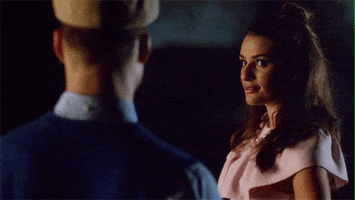 TV gif. Lea Michele as Hester on Scream Queens looks over at a man, and tried to be flirty as she winks at him.