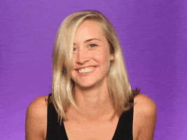 Video gif. A woman laughs and smiles, then gives us a flirtatious wink.