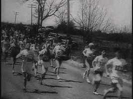 Sports gif. Black and white footage of a crowd of runners going by in the 1946 Boston Marathon.