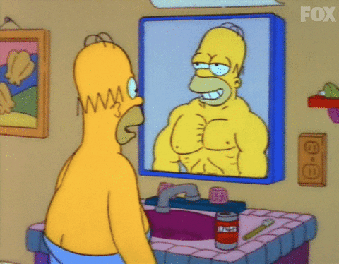 An ordinary Homer Simpson looks in the mirror to see a more athletic version of himself gif