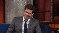 TV gif. While being interviewed on the Late Show with Stephen Colbert, Adam Brody looks down, biting his lip and then shrugs in guilt or frustration. He looks over at Stephen Colbert, who is off screen, and says “What’are you gonna do?” 