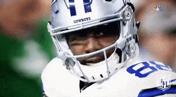 Sports gif. Dez Bryant, on the field, pointing while looking up and to the right.