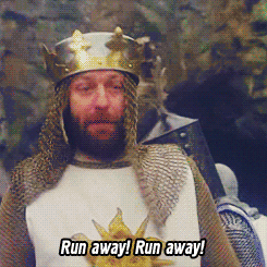 Movie gif. Graham Chapman as King Arthur in Monty Python and The Holy Grail saying, "Run away, Run away!" then exiting frame to reveal his knights scrambling to run away from the mouth of a cave.