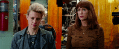 Movie gif. Kate McKinnon as Jillian and Kristen Wiig as Erin in Ghostbusters both turn their heads inward, making eye contact and giving each other knowing looks.