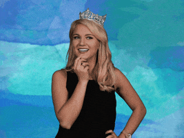Celebrity gif. Miss America Savvy Shields with her hand on her hip and her other hand on her chin, cringing and smiling.Text, "Yikes."