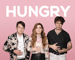 Celebrity gif. The band Echosmith looks at us with worried expressions as they rub their tummies. Text, “Hungry.”