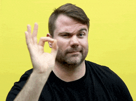 Video gif. Man raises one eyebrow at us and flashes an "ok" symbol with his hand reassuringly.