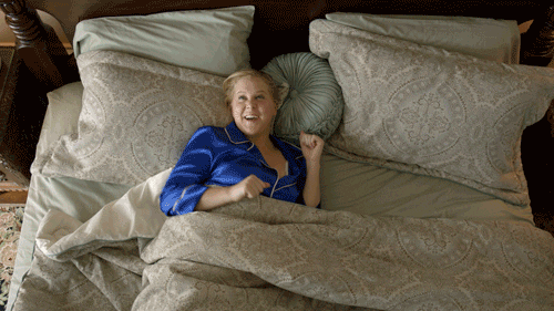 women in bed excited to start her day