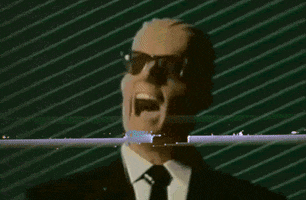 Video gif. A computer rendering of a man in sunglasses and a suit has his mouth open in pain. The screen goes fuzzy once in a while and it feels like we're watching an old VHS.
