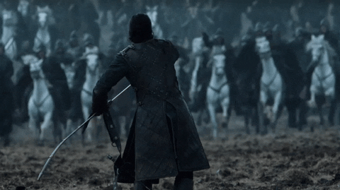 This gif shows a man drawing his sword in front of an advancing army on horseback.