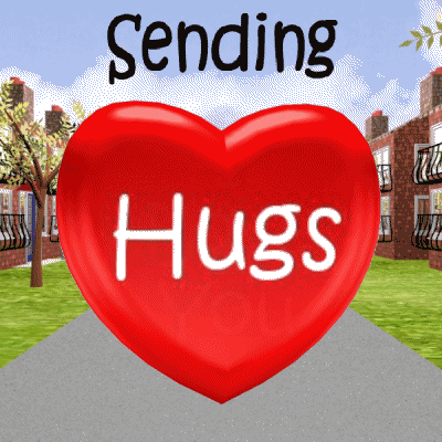 Text gif. A heart spins as it moves past city buildings toward us. Text, “sending hugs.”
