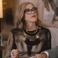 Schitt's Creek gif. Catherine O'Hara as Moira sits up pleased and claps her hands excitedly.