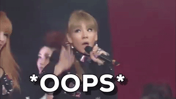 Celebrity gif. CL from Korean Pop group 2NE1 is singing and dancing on stage. She puts her hand to her lip and looks upwards, pretending to be shocked. Text, "Oops!"